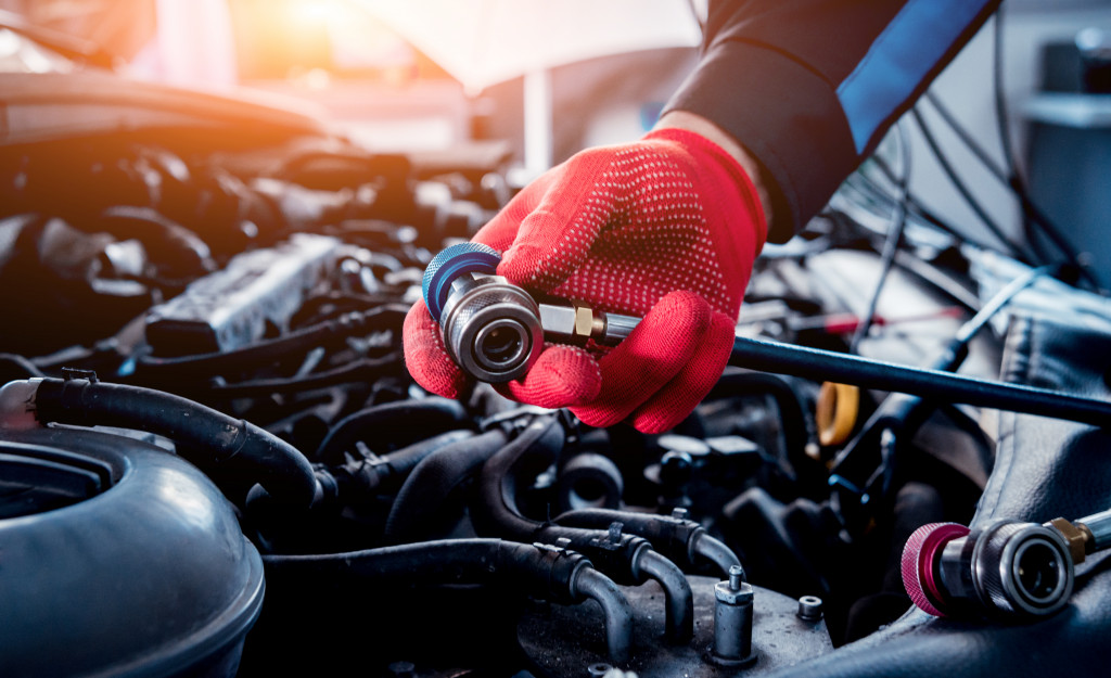 man fixing car engine